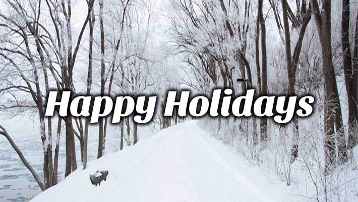 Snow covered walkway in a forest with the text Happy Holidays.